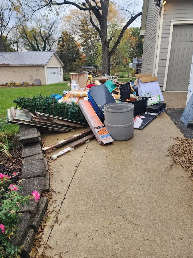 Dumpster being loaded with debris for 12 Yard Dumpster Rental in Dandridge